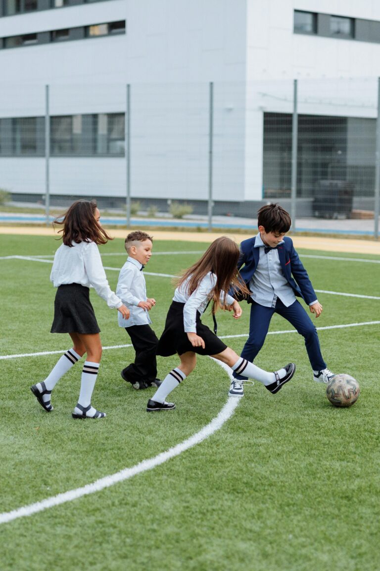 Teacher- coaching -children- in -football-